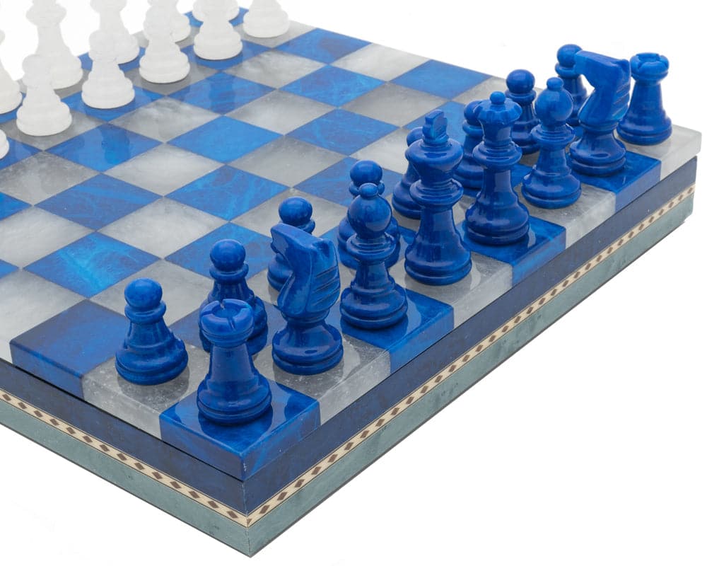 Blue and white alabaster chess pieces on inlaid wooden board, handmade in Italy by Scali Alabastro.