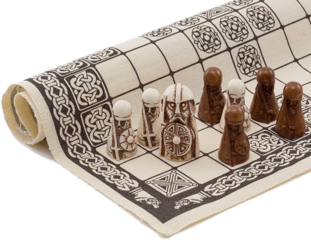 Hnefatafl Viking Board Game pieces on a linen playing surface with intricate designs