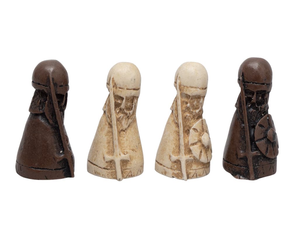 Four medieval chess pieces featuring warriors with shields and swords, two in brown and two in beige.