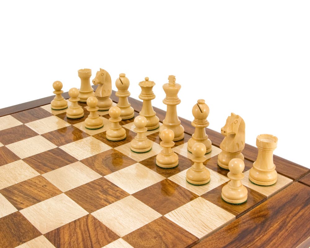 Ebonised Staunton chess pieces setup on wooden chess board