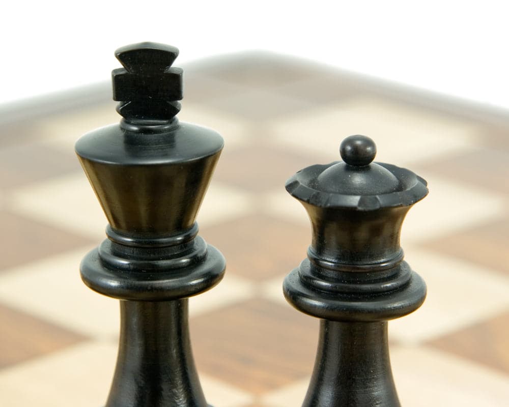 Down Head Knight Ebonised Staunton chess king and queen pieces on a chessboard.