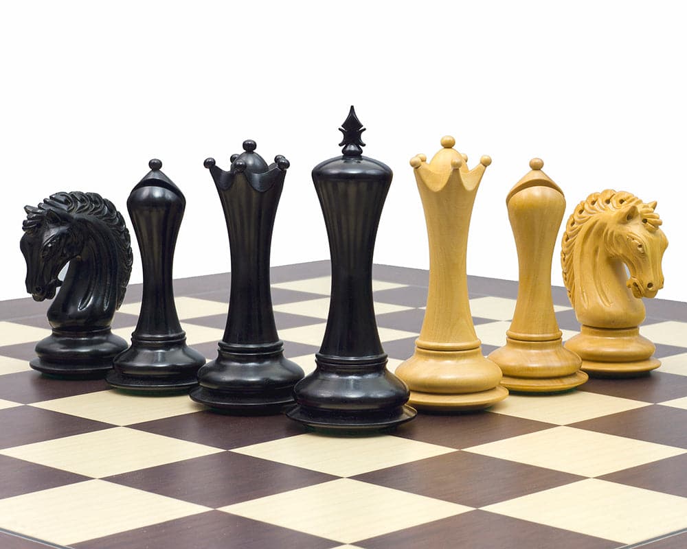 The Empire Knight Ebony Chessmen 4.5 inch set on a chessboard, featuring handcrafted, weighted pieces with an elegant Staunton design.