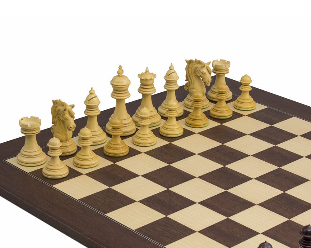 The Kingsgate Rosewood Chessmen 4.25 inch set up on a chessboard, featuring ornate handcrafted pieces with a 4.25 inch king and extra queens