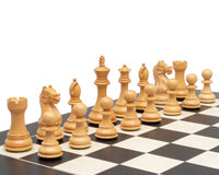 Natural wooden chessmen set up on a black and white chessboard, featuring carved pieces including pawns, knights, rooks, bishops, queen, and king.