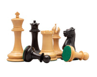 Classic Staunton ebony and rosewood chess pieces on display with green felt bases, featuring king, bishop, rook, knight, and pawns.
