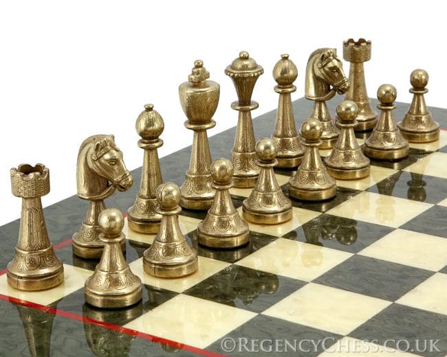 Finnesburg Brass and Olive Luxury Chess Set with detailed decorative embossing on a marble board.