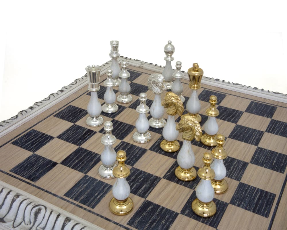 The San Severeo Chess Set on ornate board with gold and silver pieces.