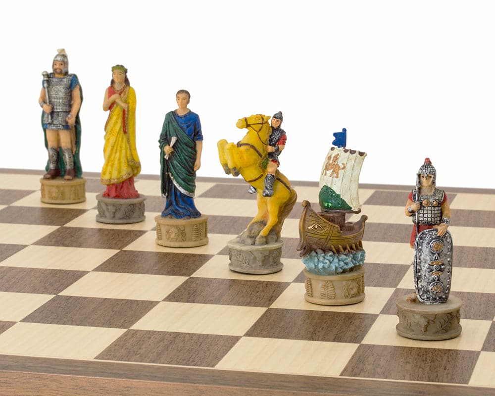 Hand painted chess set showing characters from The Battle of Troy, including a knight on horseback and a ship, on a wooden chessboard