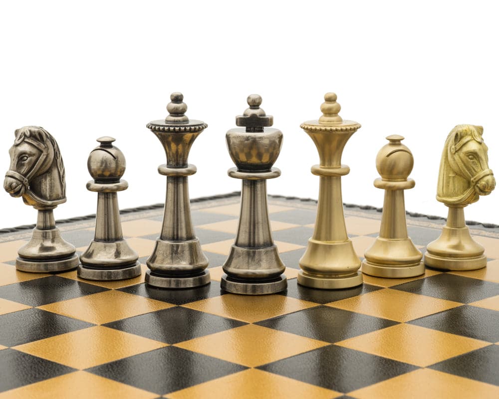 Luxury Staunton design chess pieces made from ebony on a black and brown chessboard with intricate details and a regal king piece.