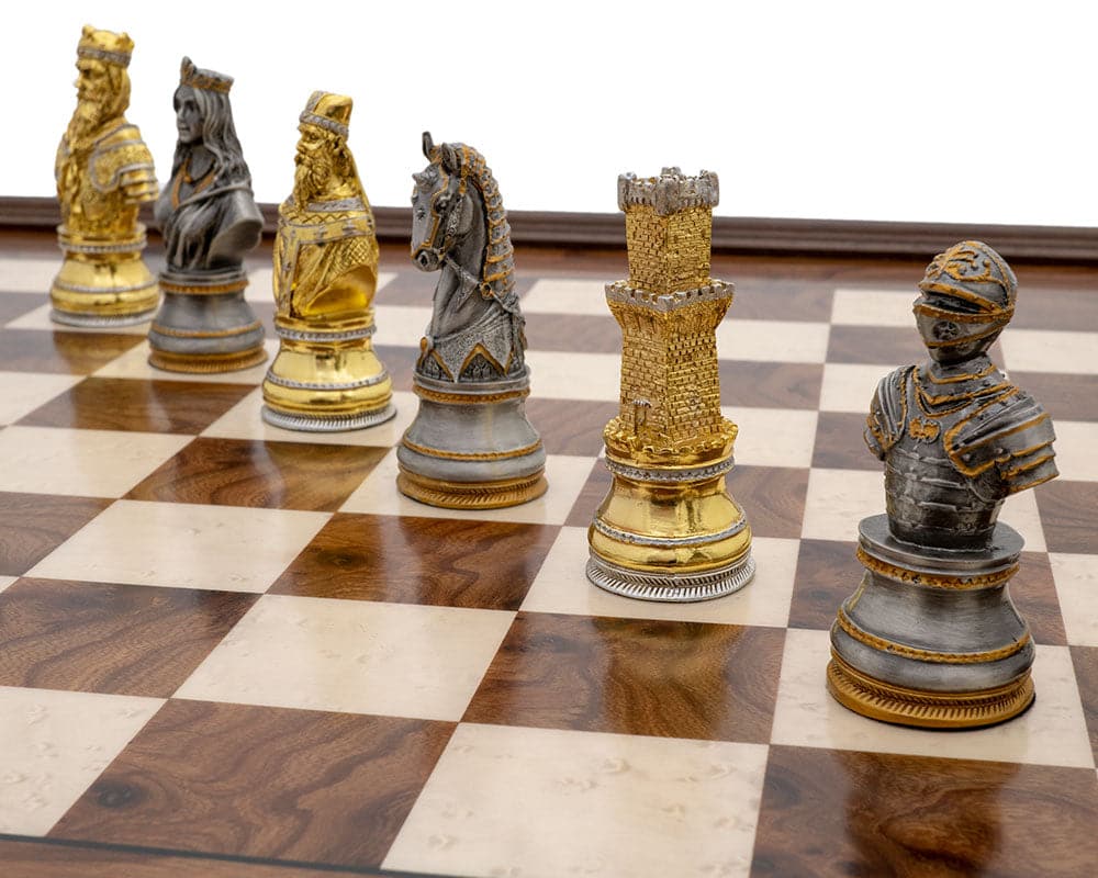 Pewter and briarwood luxury chess pieces on a Medieval-themed chessboard set